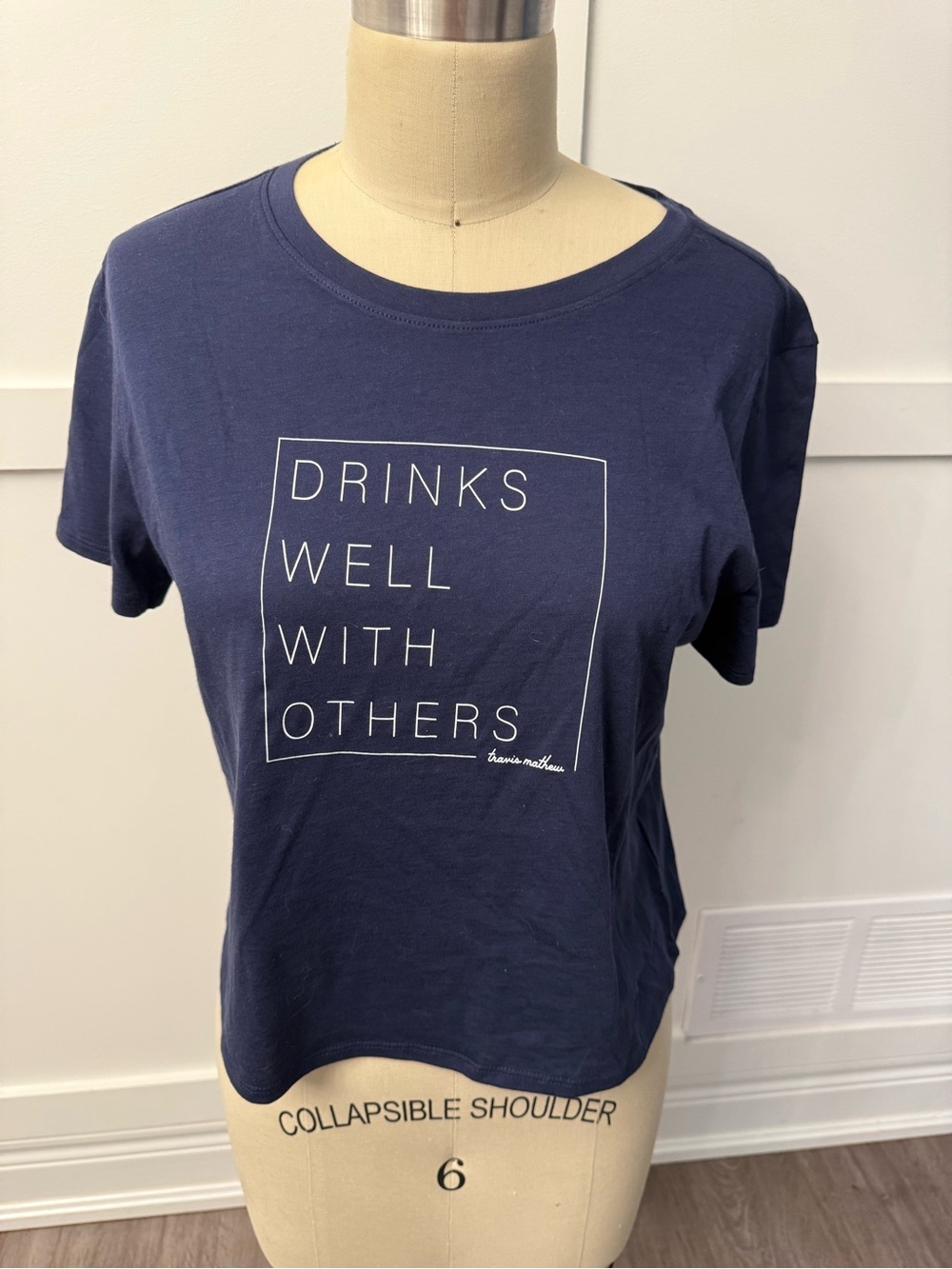 Travis Mathew Navy Short Sleeve Tee with White Boxed Text